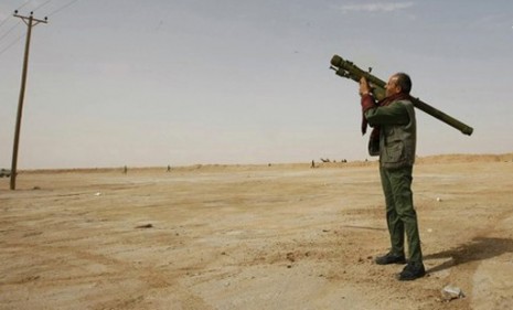 A rebel fires a rocket at Moammar Gadhafi-loyal forces earlier this month. 