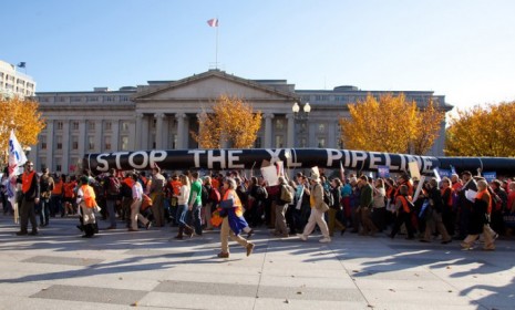 Protesters form a 12,000-person human chain around the White House on Sunday, and call for President Obama to say no to the proposed 1,700-mile Keystone XL oil pipeline from Canada to the Gul