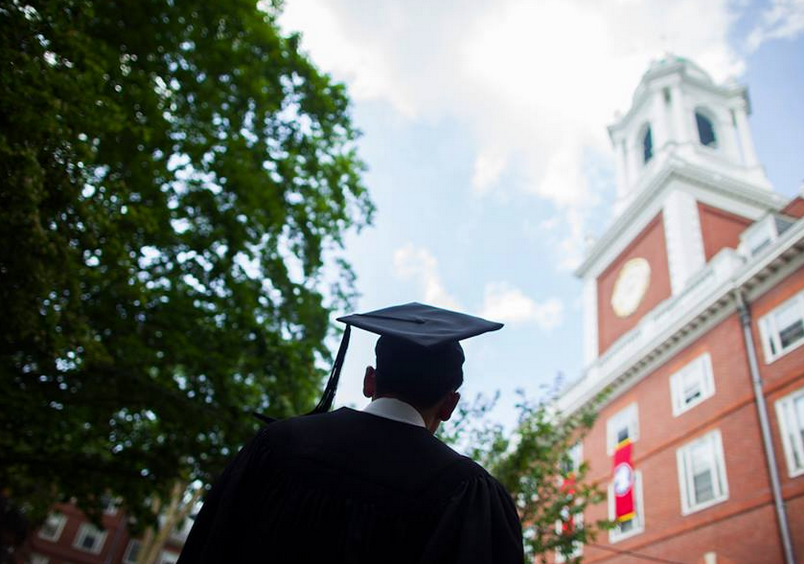 A student in graduation attire at Harvard University