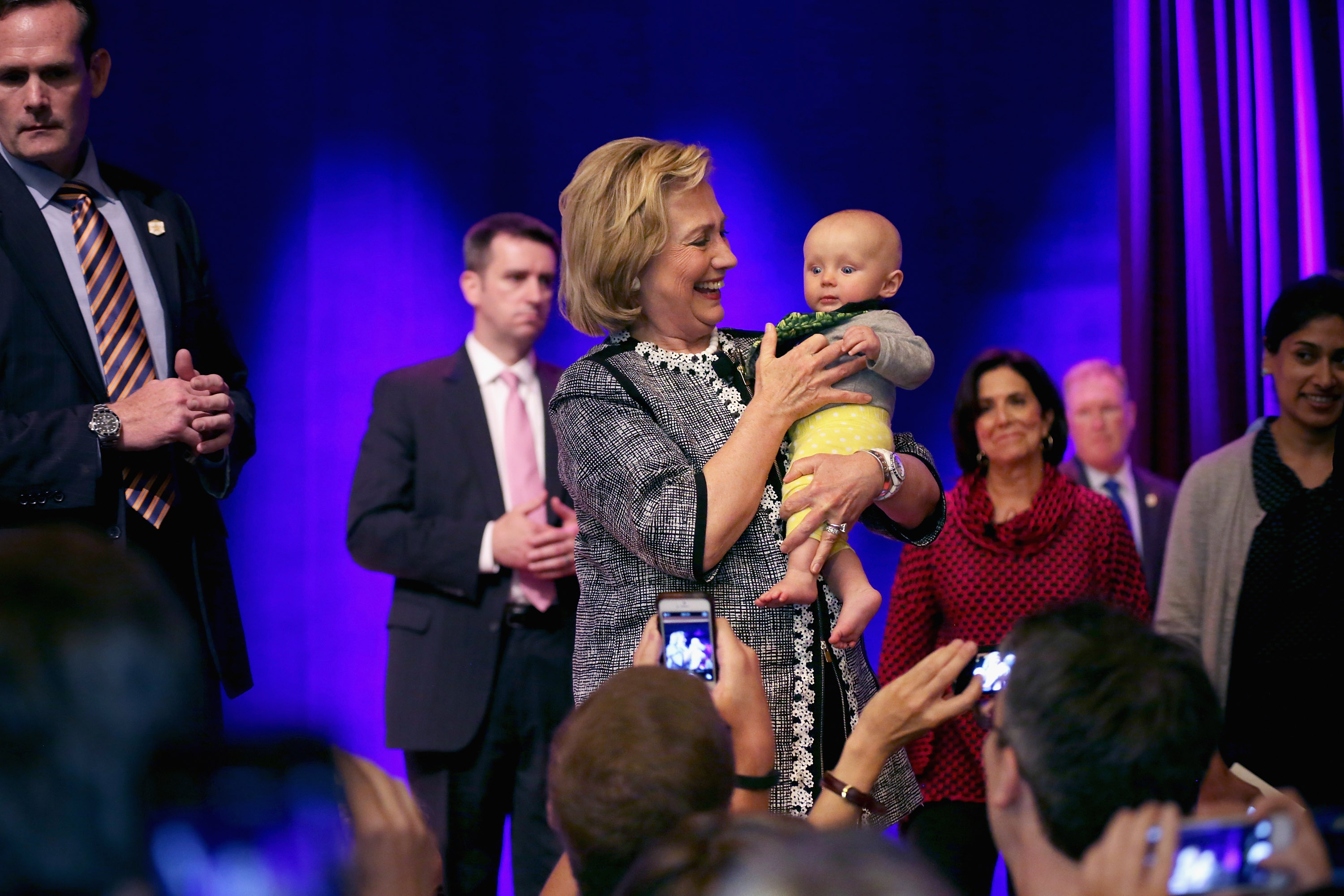 Hillary Clinton holds up a baby during her 2014 book tour.