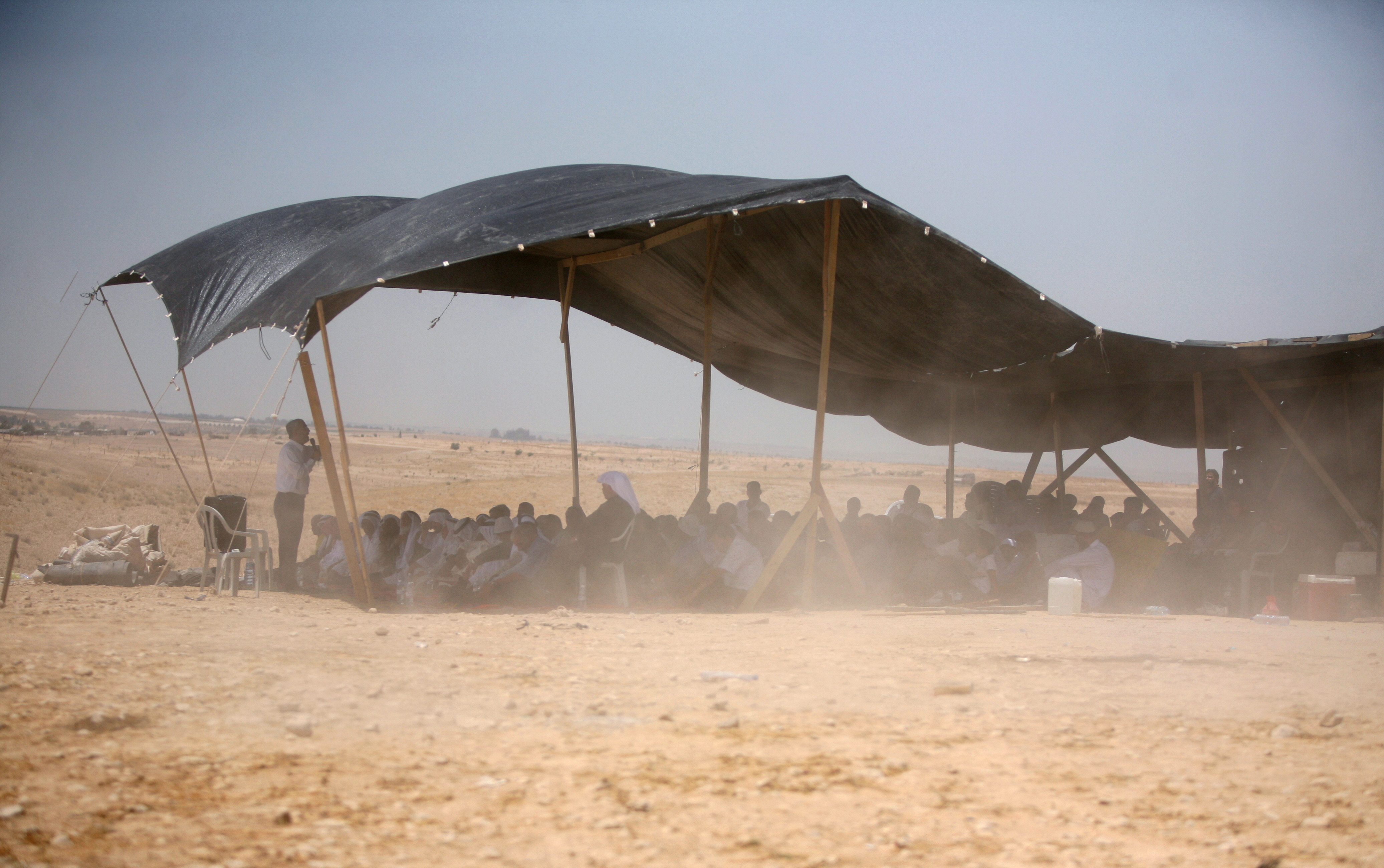 Bedouins attend Friday prayer under a tent in the Al-Araqib village.
