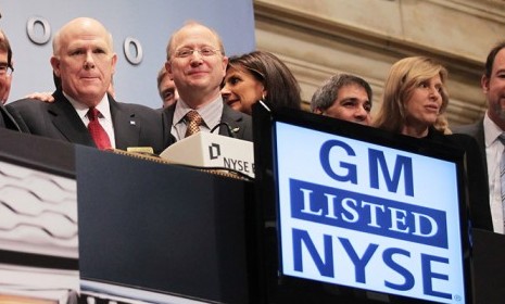 GM CEO Dan Akerson (red tie) rings the opening bell of the New York Stock Exchange Thursday.