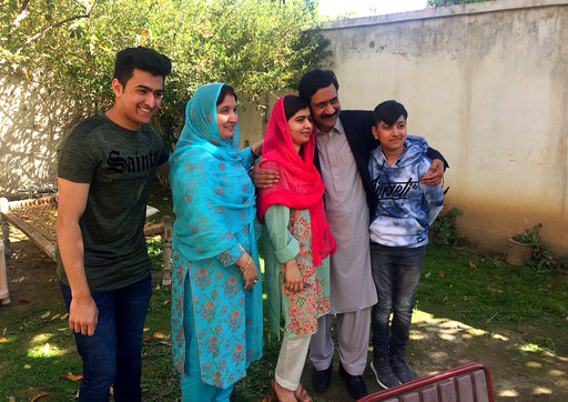 Pakistan&#039;s Nobel Peace Prize winner Malala Yousafzai, center, poses for a photograph with her family members at her native home during a visit to Mingora, the main town of Pakistan Swat Valle