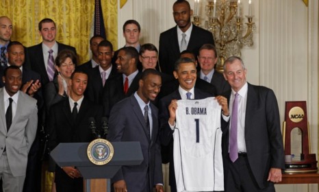 President Obama poses with the 2011 NCAA Champion University of Connecticut team: The NCAA is vowing major changes to college sports&#039; rules but critics are doubtful.