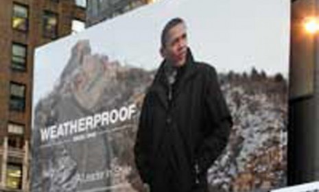 Without asking his permission, outerwear company Weatherproof used a news photo of Barack Obama wearing one of its jackets on a Times Square billboard. (AP Photo/Julie Jacobson)