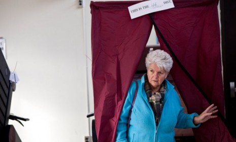 A woman exits a voting booth