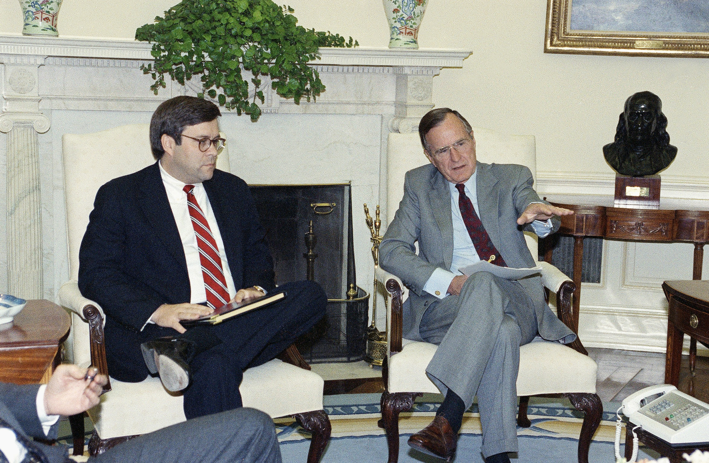 William Barr and George H.W. Bush.