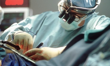 A doctor performs open heart surgery