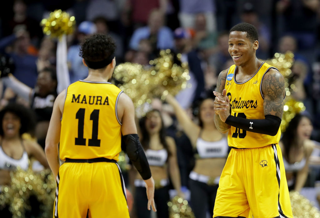 Jairus Lyles #10 congratulates teammate K.J. Maura #11 of the UMBC Retrievers after their 74-54 victory over the Virginia Cavaliers during the first round of the 2018 NCAA Men&#039;s Basketball To