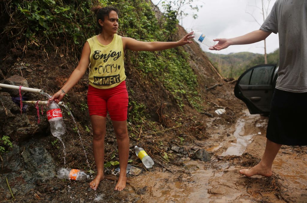 A woman gathers water in Puerto Rico