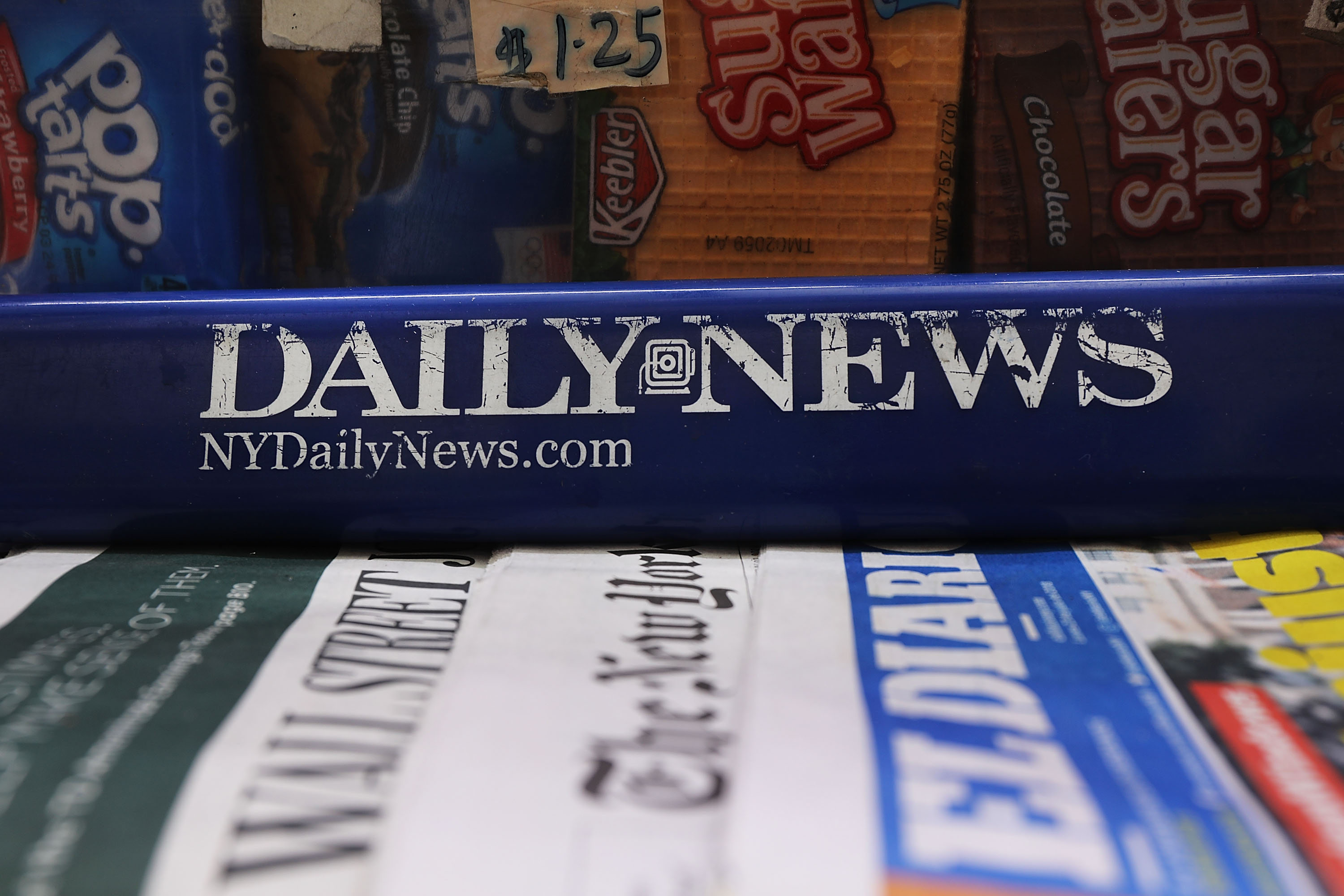 The New York Daily News logo on a newsstand