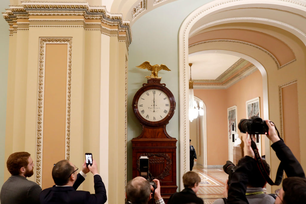 The Ohio Clock outside the Senate Chamber strikes midnight at the U.S. Capitol January 20, 2018, beginning the government shutdown