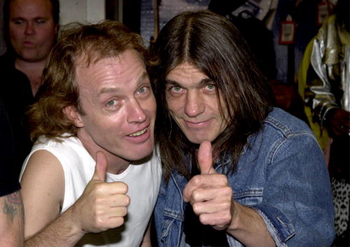 Band members Angus Young, left, and brother Malcolm Young of the Australian rock band AC-DC pose September 15, 2000 at the Rock Walk handprint ceremony at the Guitar Center in Hollywood