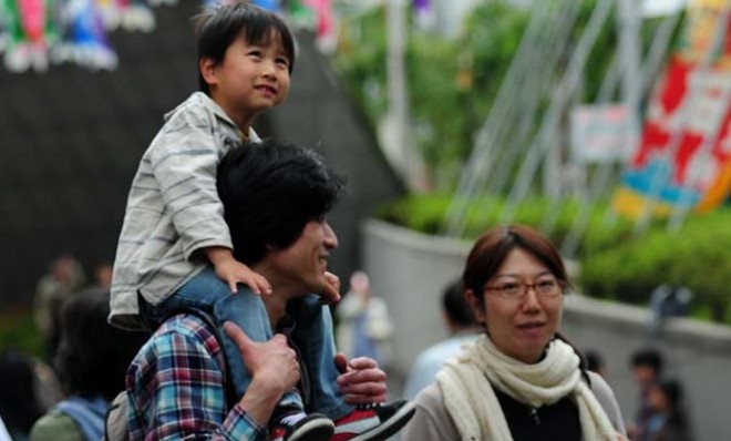 A young Japanese family admires decorations in Tokyo
