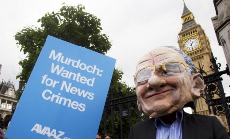 A protestor wearing a Rupert Murdoch mask