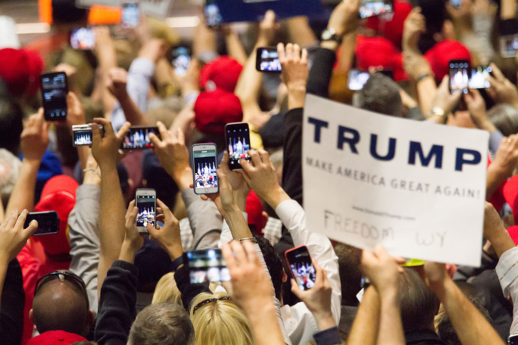 Donald Trump supporters with phones.