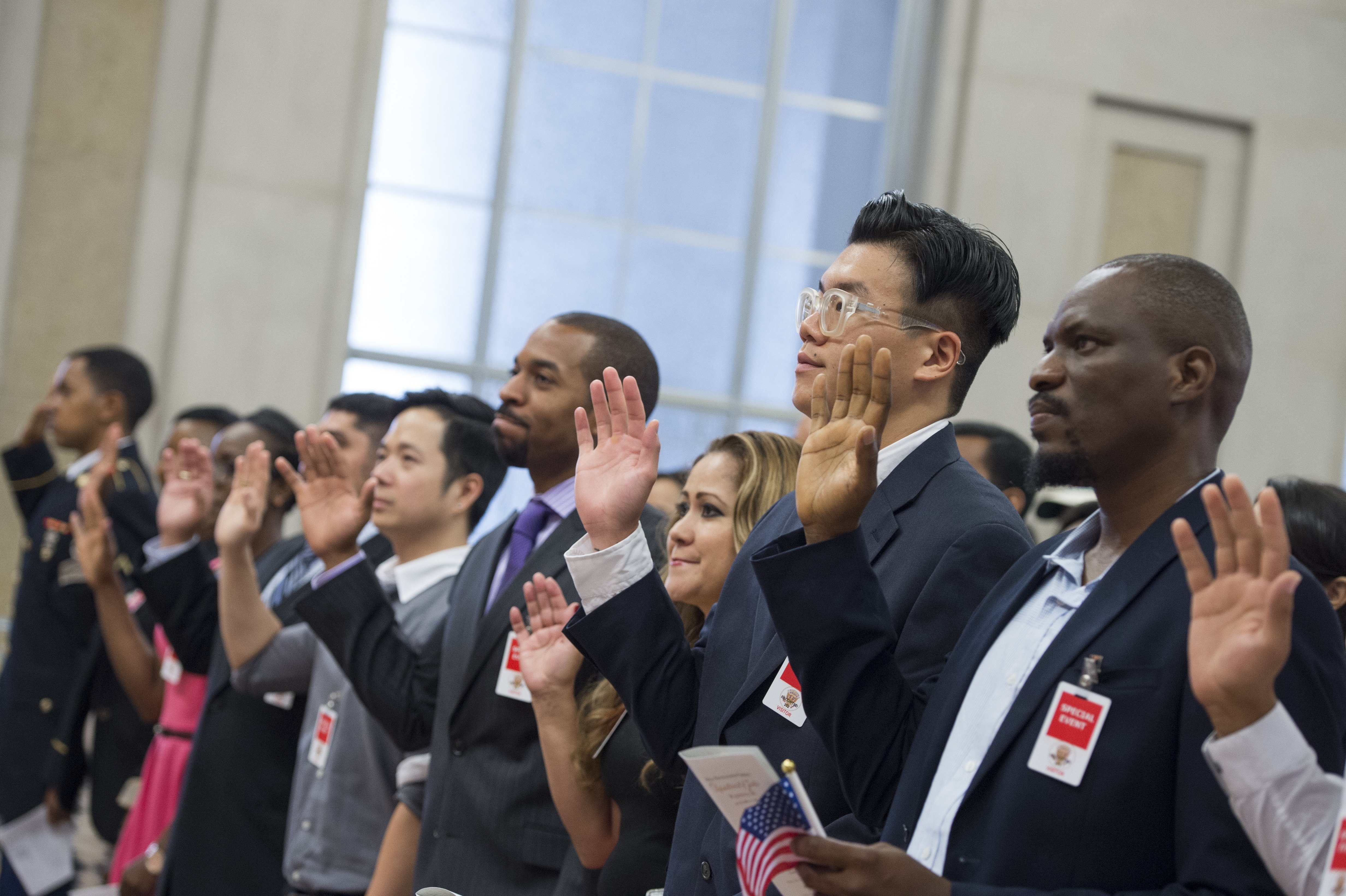 A group of immigrants become naturalized as U.S. citizens. 
