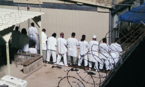 Detainees participate in early morning prayers at Guantanamo Bay: At least 150 innocent people have been held at Guantanamo, according to new WikiLeaks documents. 