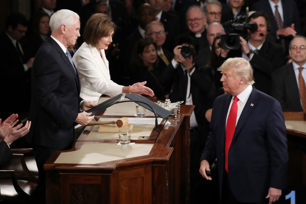 Nancy Pelosi reaches out to shake Trump&#039;s hand.