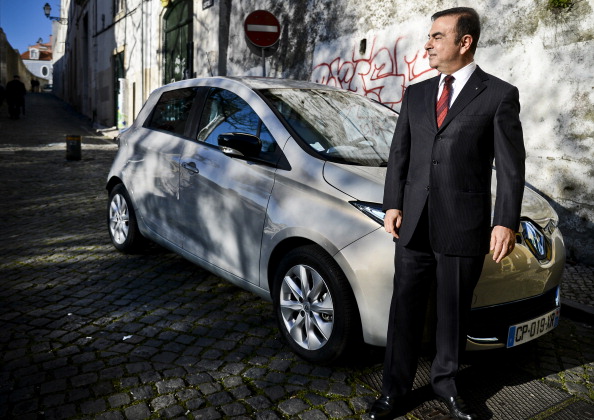 Chairman and CEO of France-based Renault, Carlos Ghosn, stands with one of the company&#039;s electric cars in 2013.