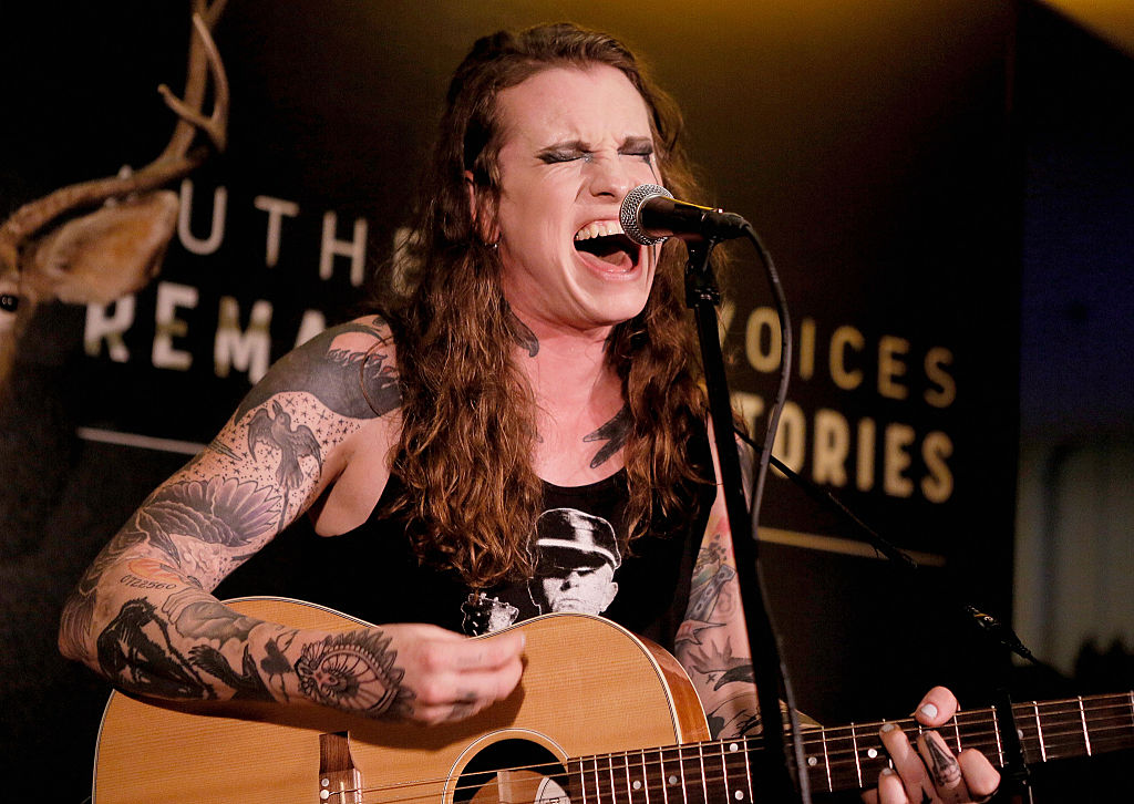 Against Me! singers burns birth certificate in protest. 