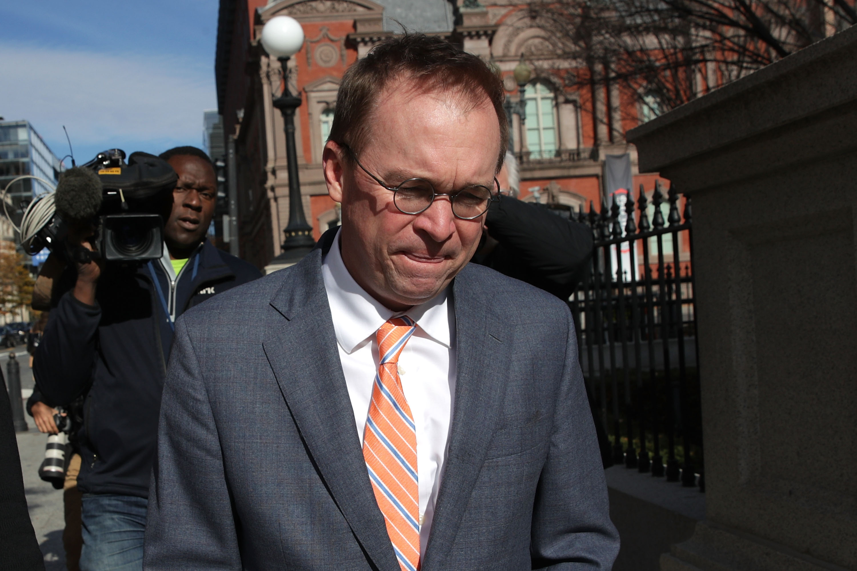 Mick Mulvaney walks to the White House