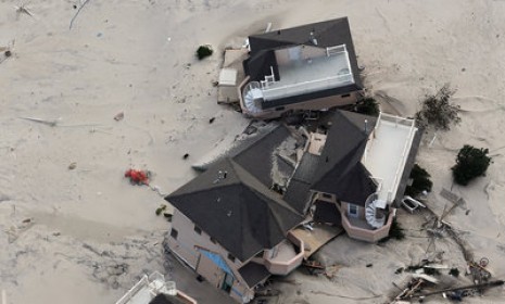 Homes wrecked by superstorm Sandy in Seaside Heights, N.J.: Some 2 million people have had their power restored on the East Coast, but another 6 million remain in the dark.