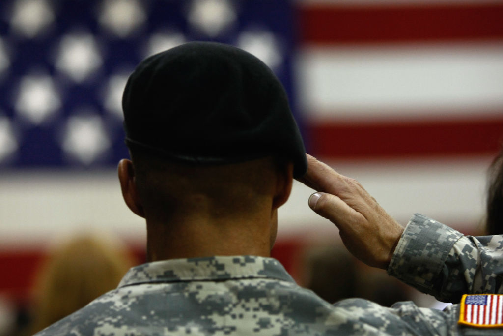 A U.S. Army soldier salutes during the national anthem as soldiers return home from Iraq on August 29, 2009 in Fort Carson, Colorado.