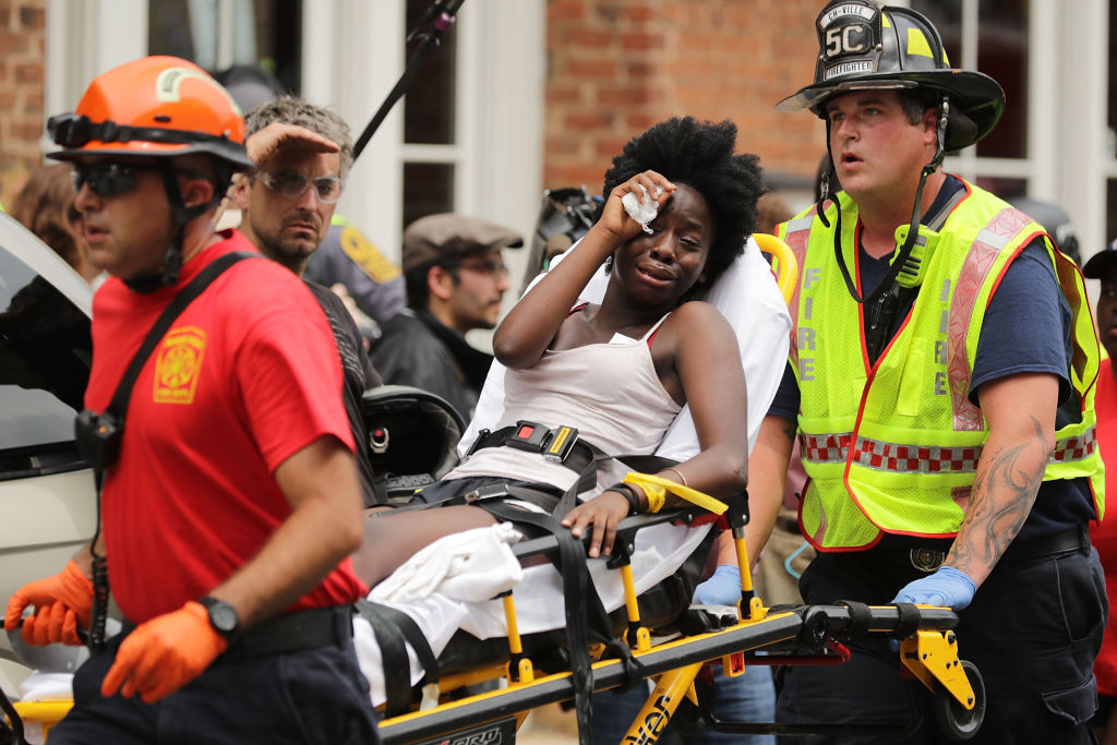  Rescue workers move victims on stretchers after car plowed through a crowd of counter-demonstrators marching through the downtown shopping district August 12, 2017 in Charlottesville, Virgin