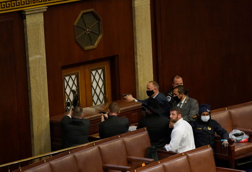 Police hold armed standoff at House chamber door.