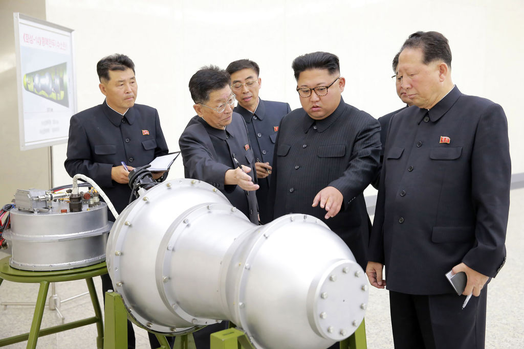 North Korean leader Kim Jong Un looks at a weapon