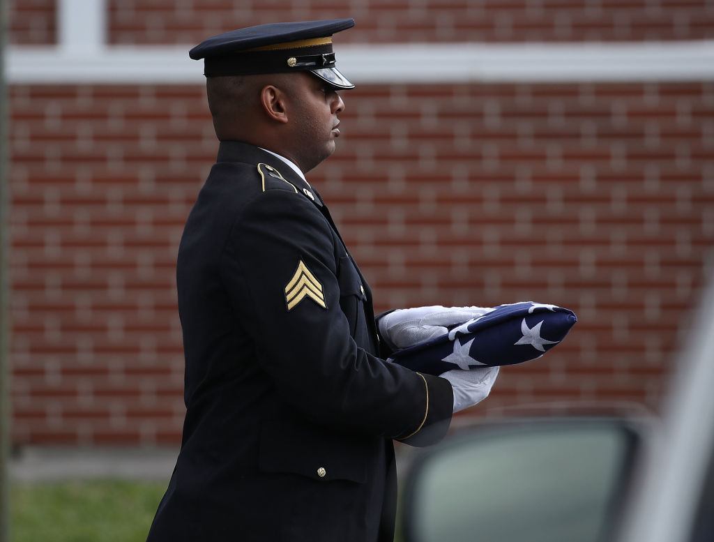 A flag is carried into the funeral of Alaina Petty.