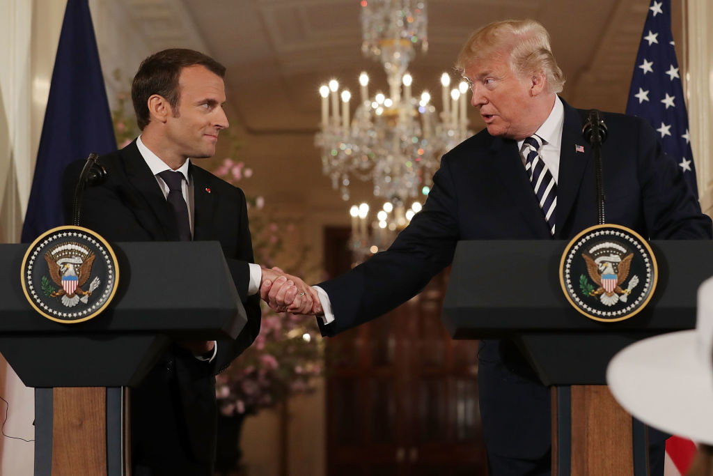 Macron and Trump shake hands.