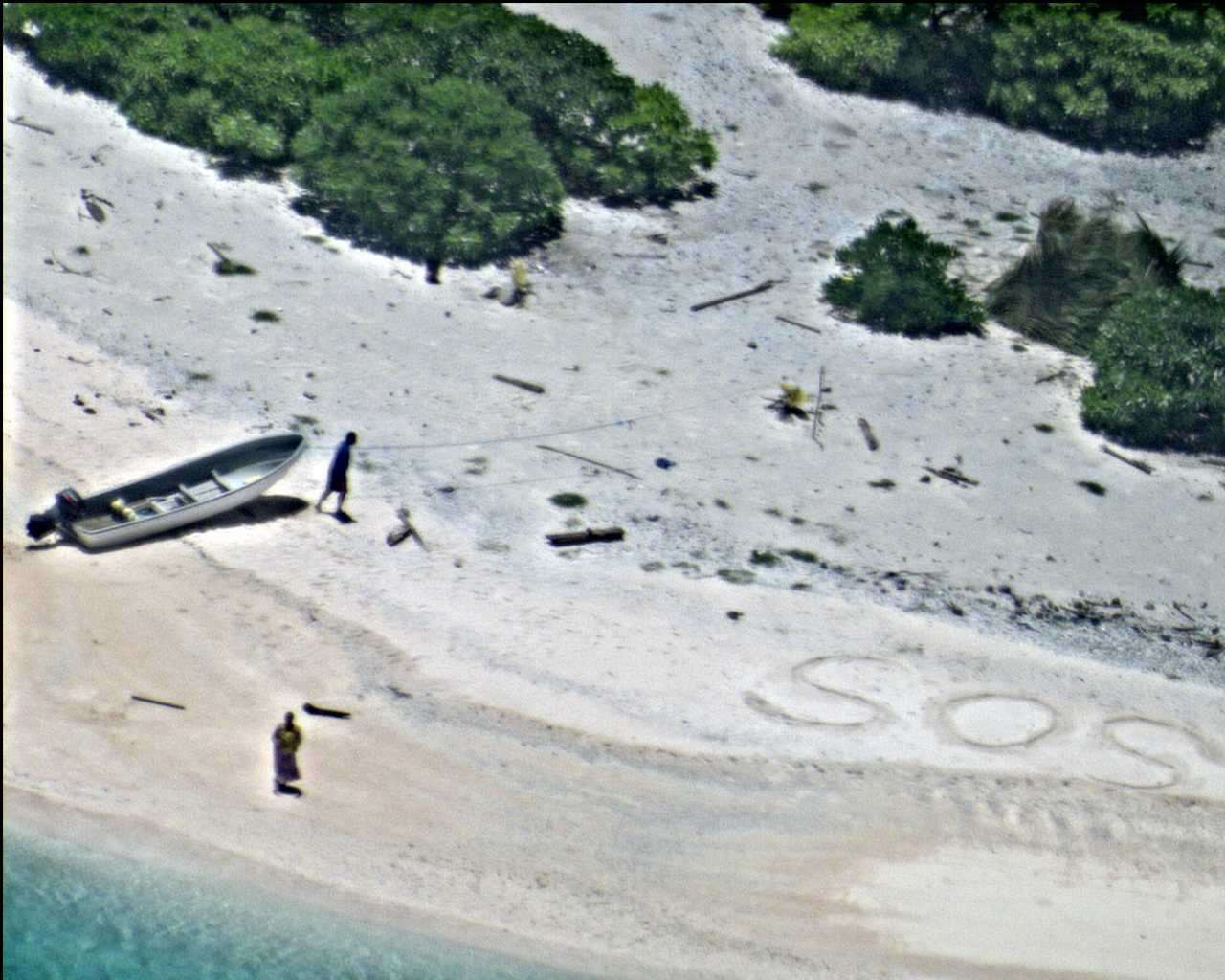 Two people were rescued from a desert island after they wrote &#039;SOS&#039; in the sand