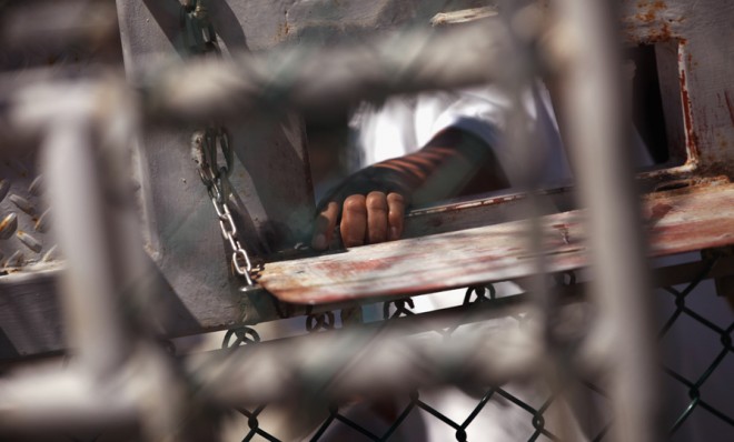 A Guantanamo Bay detainee waits for lunch inside the detention center on Sept. 16, 2010.