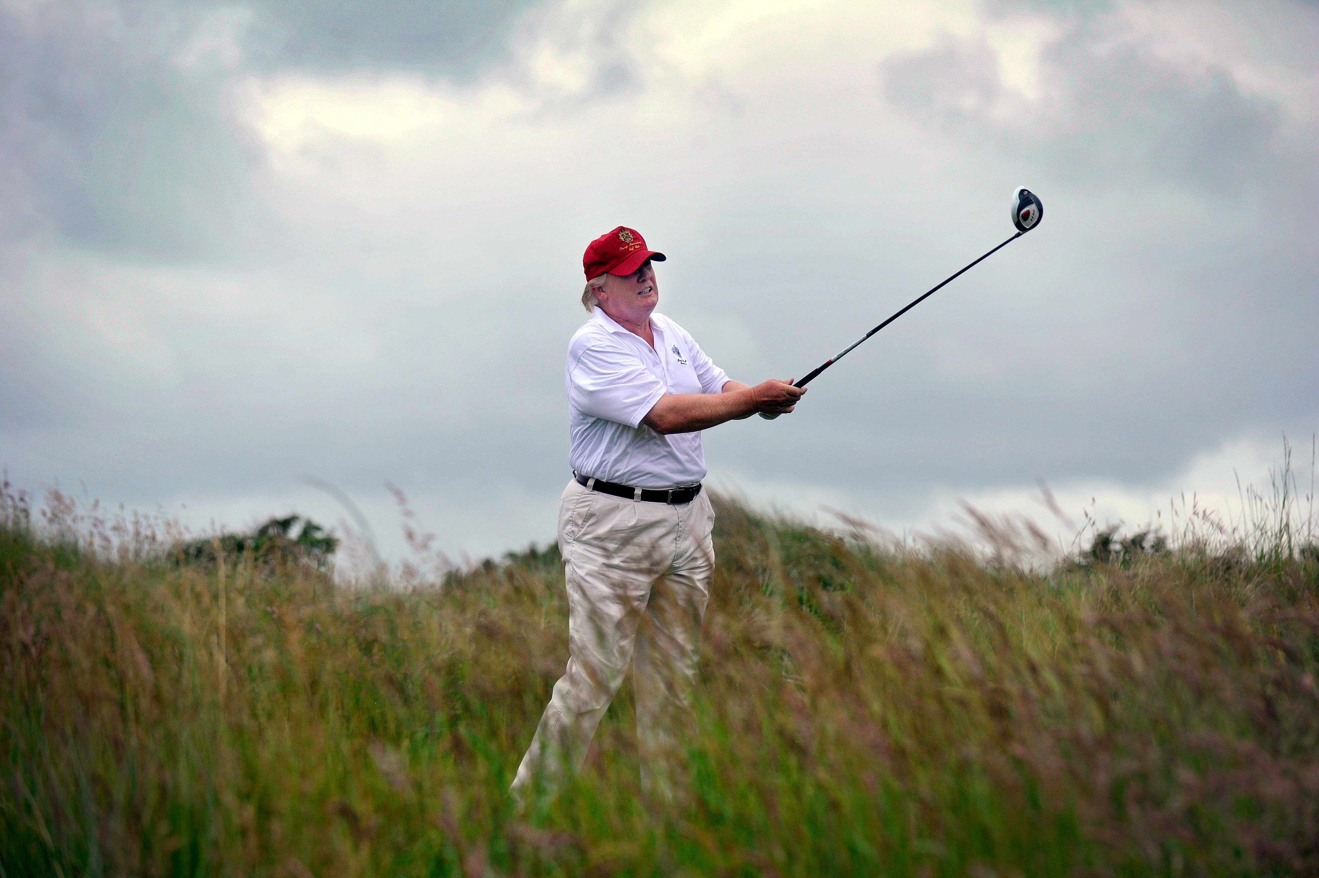 Donald Trump plays a stroke at the Trump International Golf Links course.