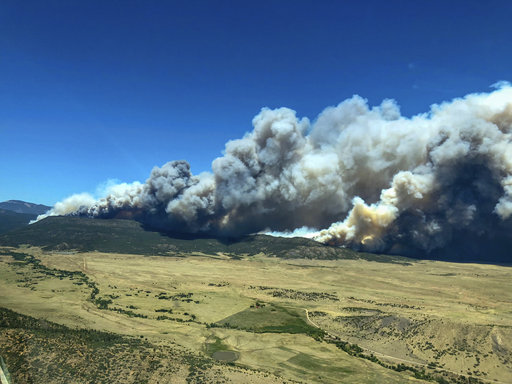 Plumes of smoke from a wildfire near Cimarron, N.M., rise in the background Friday, June 1, 2018. 