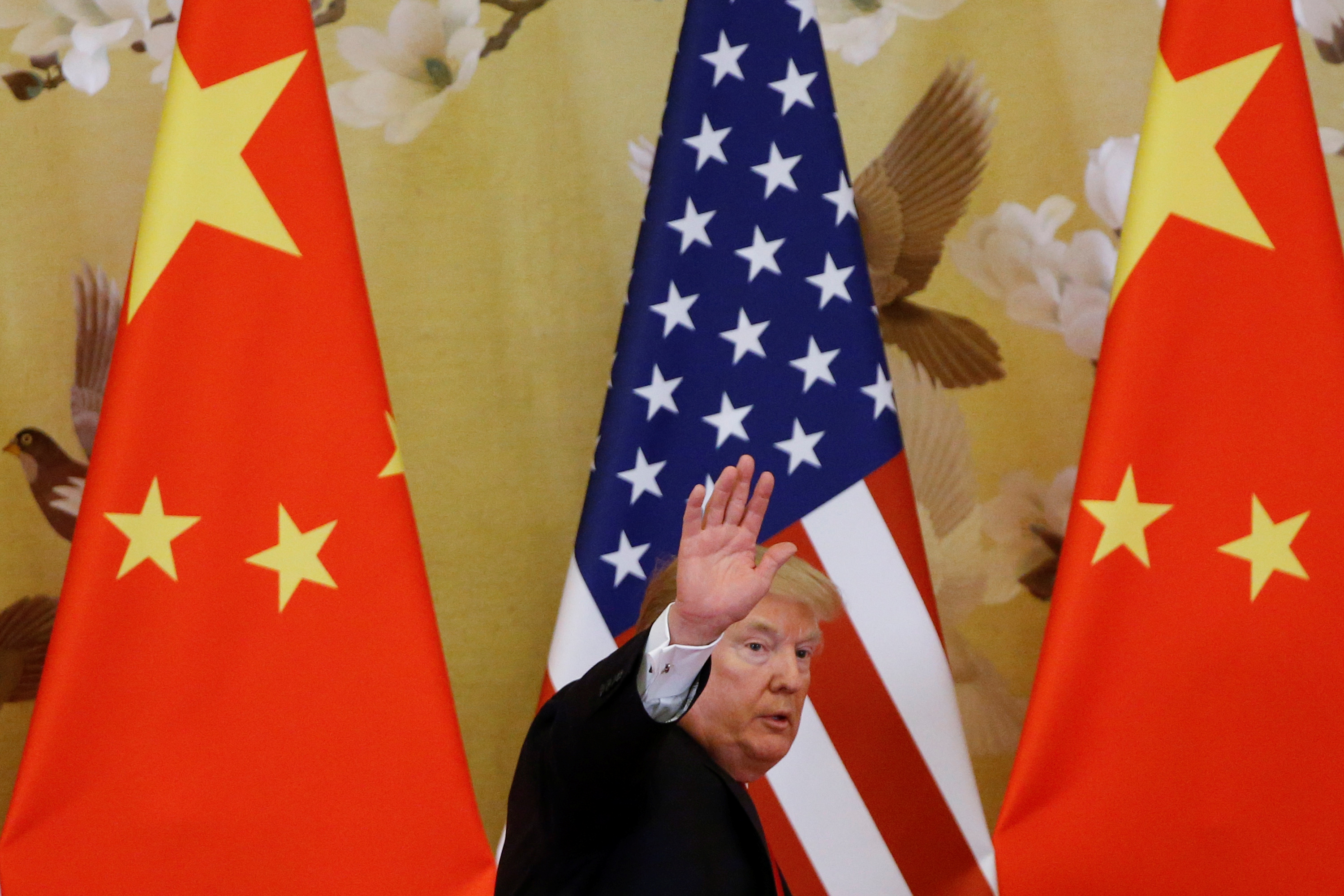 President Donald Trump with Chinese and American flags.