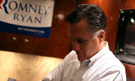 Mitt Romney rides his campaign bus en route to a campaign rally in Avon Lake, Ohio, on Oct. 29.