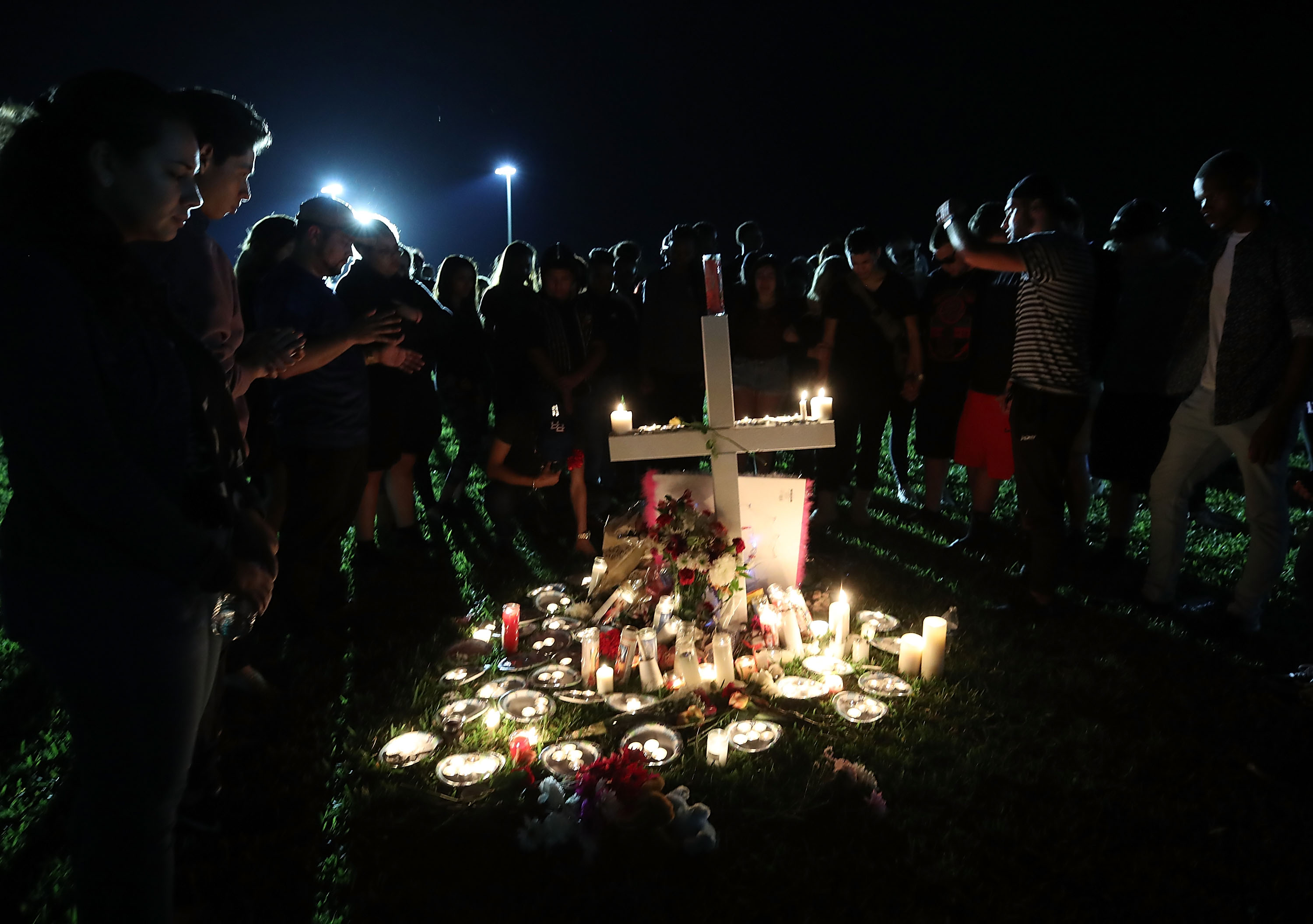 People attend a vigil for shooting victims in Florida