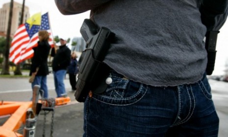 A Tea Party activist displays his gun at a rally.