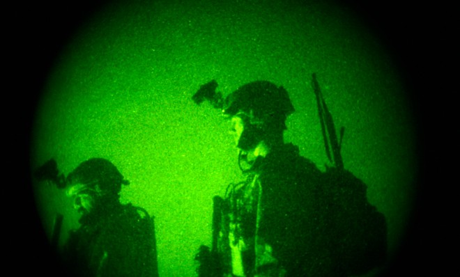 U.S. Special Operations forces are seen through a vision night scope in Afghanistan, Dec. 11, 2011.