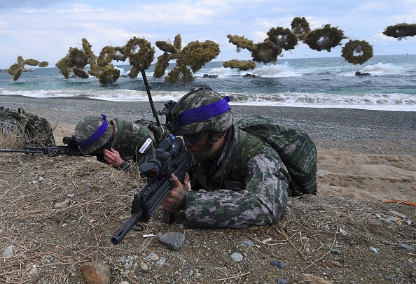  South Korean Marines take position on a beach as amphibious assault vehicles fire smoke shells during a joint landing operation by US and South Korean Marines 