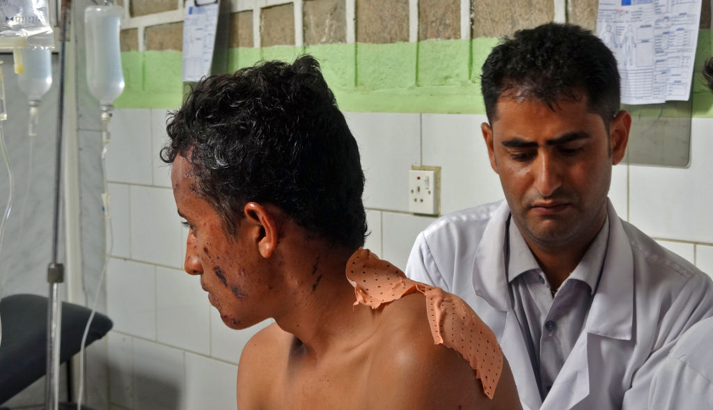 A Yemeni man gets medical treatment after surviving an airstrike.