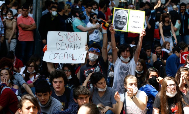Turkish protesters  hold up signs, including one that reads &quot;rebellion, revolution, liberty,&quot; during demonstrations in Ankara on June 4. 