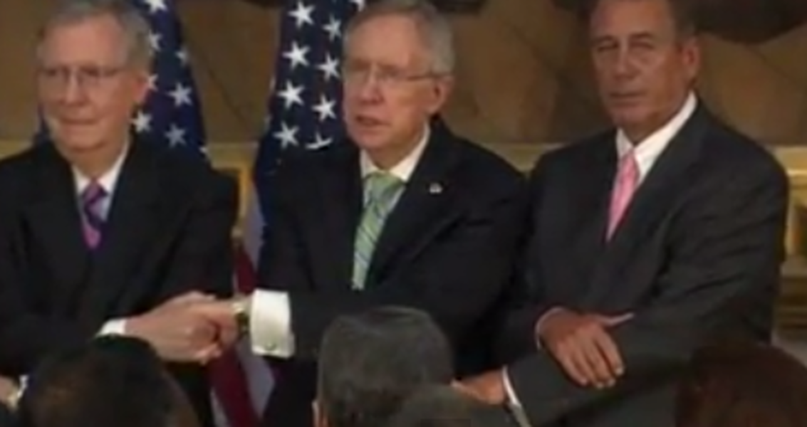 Watch congressional leaders make a truly awkward bipartisan attempt to hold hands and sing