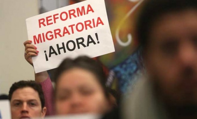 A person holds a sign written in Spanish reading &quot;Immigration Reform Now&quot; during a watch party of President Obama&#039;s speech on Jan. 29.