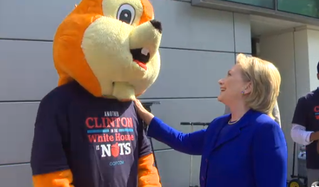 Hillary Clinton glibly confronts the giant orange squirrel sent to torment her