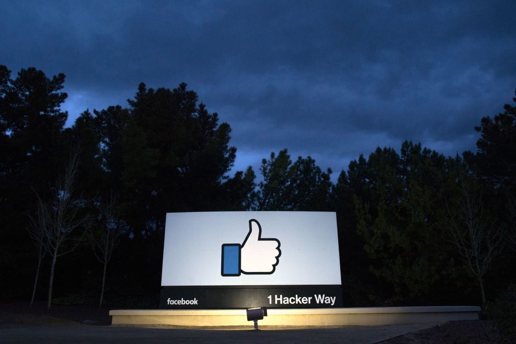 A lit sign is seen at the entrance to Facebook&#039;s corporate headquarters location in Menlo Park, California on March 21, 2018