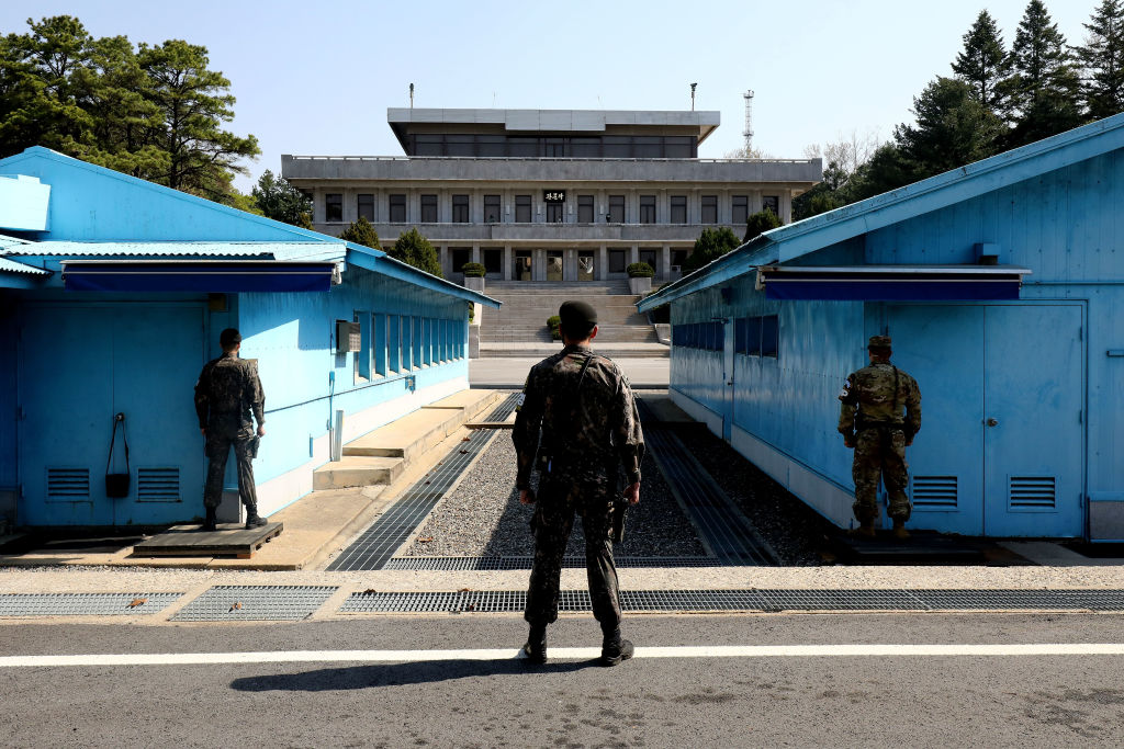 South Korean soldiers in the DMZ stare toward North Korea